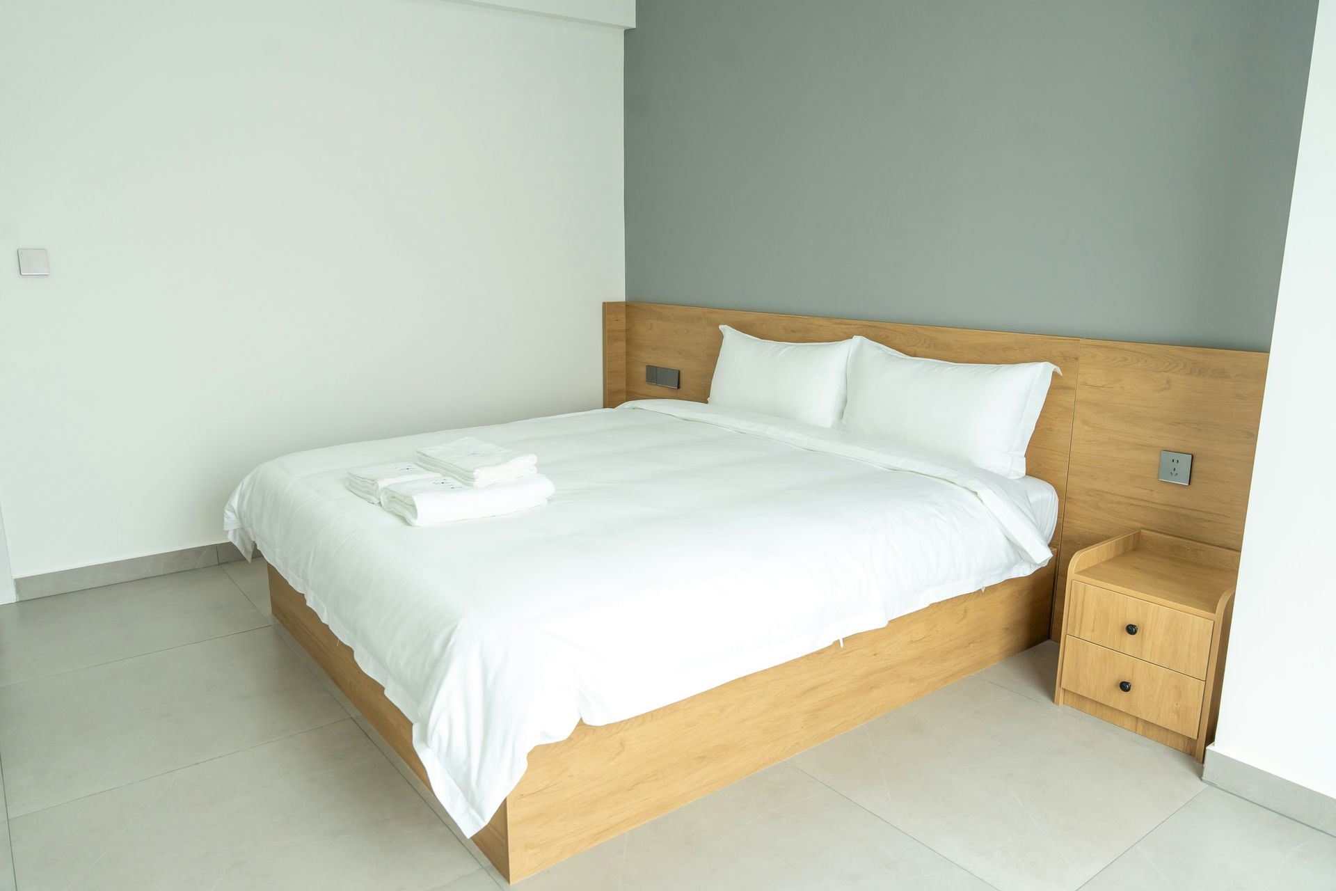 A neatly made bed in a modern hotel room